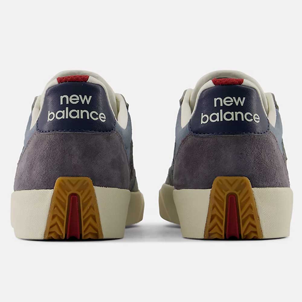 Two New Balance Numeric 340 NBA Gray Blue Green suede skateboarding shoes are shown from the back, featuring dark blue heel tabs with white New Balance text, grey suede uppers with reinforced toe caps for added durability, off-white midsoles for impact protection, and gum-colored outsoles accented with a red line detail.
