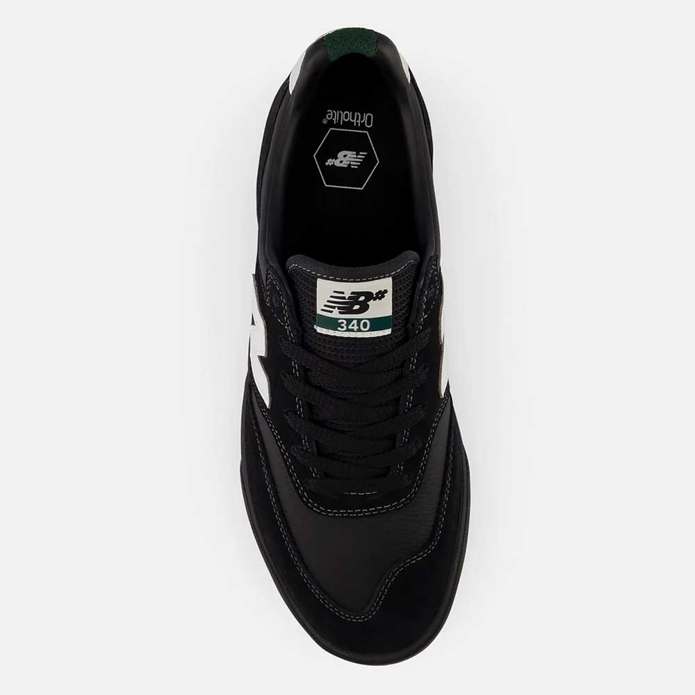 A top view of the 340 YRW Black White New Balance Numeric Suede Skateboarding Shoe, showcasing its black color with white accents, a branded white tongue label displaying the logo and model number, and a reinforced toe cap designed for enhanced durability and impact protection.