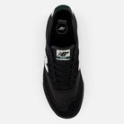 A top view of the 340 YRW Black White New Balance Numeric Suede Skateboarding Shoe, showcasing its black color with white accents, a branded white tongue label displaying the logo and model number, and a reinforced toe cap designed for enhanced durability and impact protection.