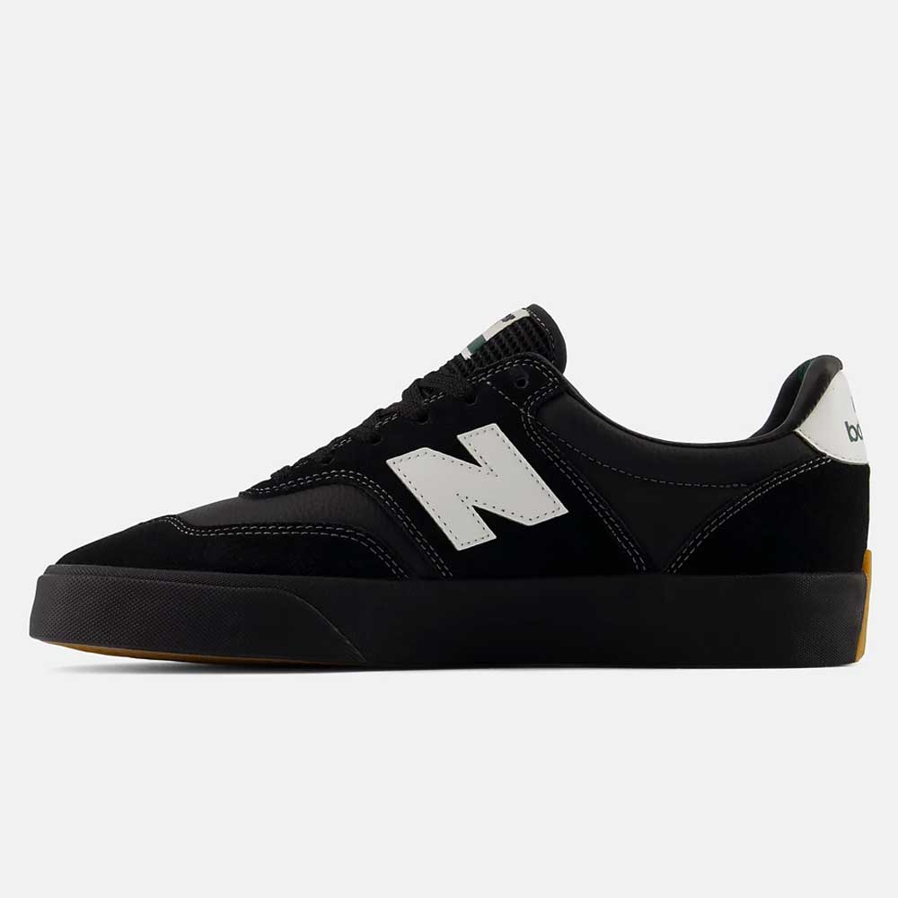 A pair of New Balance Numeric 340 YRW Black White suede skateboarding shoes, featuring a black upper with a white N logo on the side, white heel accent, black laces, gum rubber sole with impact protection, and a reinforced toe cap, displayed on a white background.