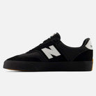 A pair of New Balance Numeric 340 YRW Black White suede skateboarding shoes, featuring a black upper with a white N logo on the side, white heel accent, black laces, gum rubber sole with impact protection, and a reinforced toe cap, displayed on a white background.