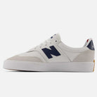 The 340 YRW New Balance Numeric Suede Skateboarding Shoes feature a white design with navy blue N logo, suede toe and heel accents, and a durable white rubber sole. The reinforced toe cap ensures added durability, while the heel sports a navy blue section with “balance” in white letters.