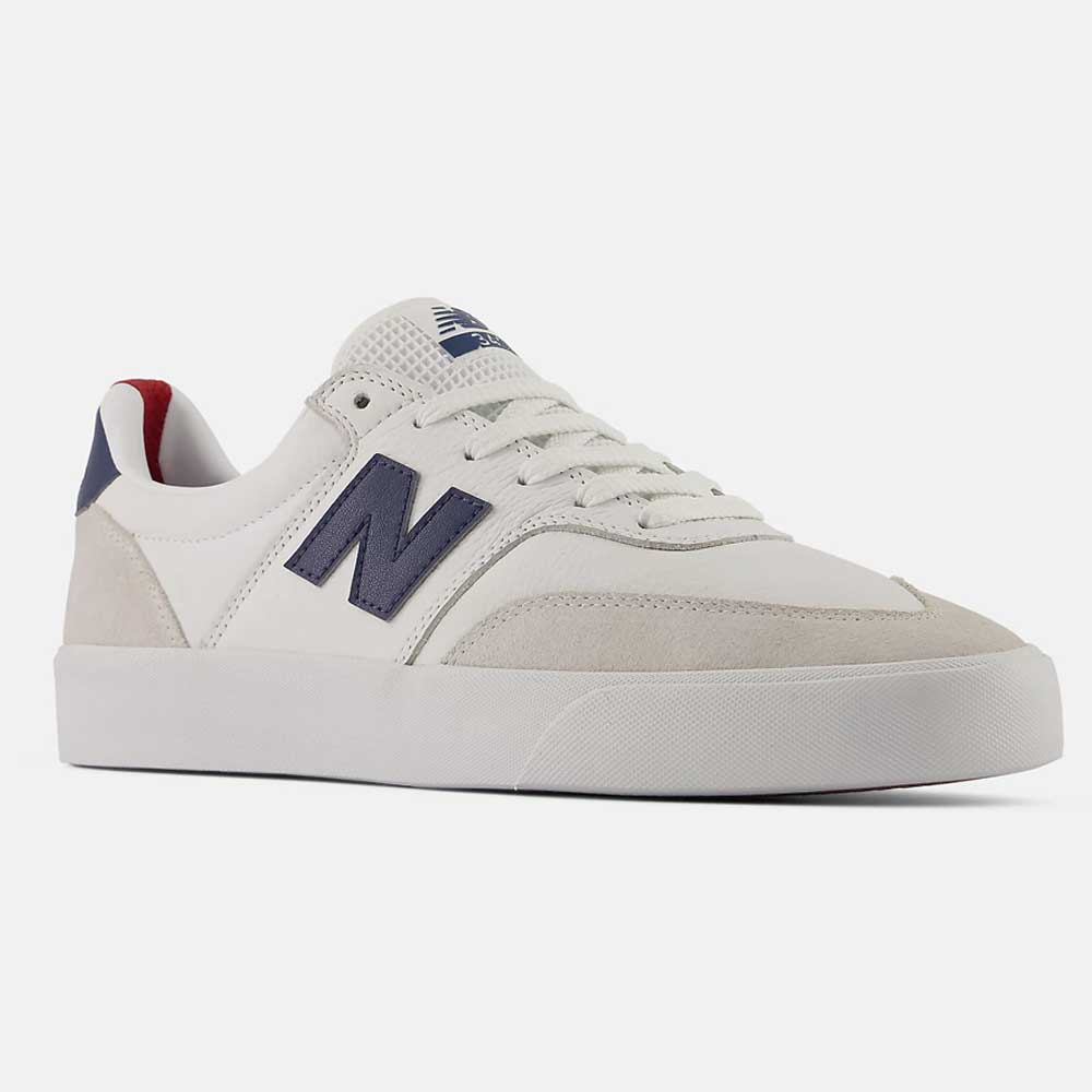 The 340 YRW New Balance Numeric Suede Skateboarding Shoes are white sneakers with a navy blue N logo on the side, suede accents, white laces, and a reinforced toe cap for enhanced durability. Designed with a rubber sole, these shoes are displayed at an angle on a plain white background.