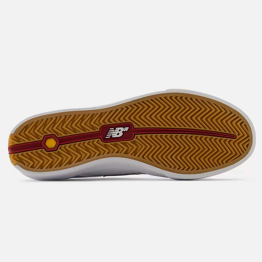 The bottom of the 340 YRW New Balance Numeric Suede Skateboarding Shoe showcases a gum sole with a red line detail and a white NB logo centered, featuring a herringbone traction pattern for impact protection.