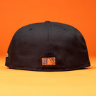 A BLVCK STAR Houston Astros New Era 5950 Fitted Hat is displayed from the back against an orange background, showcasing a small rectangular orange and blue Houston Astros logo near the bottom center.
