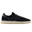 The 440 BCO Black White New Balance Numeric Suede Skateboarding Shoe is a black low-top sneaker featuring white stitching, white laces, and a beige sole. It showcases a prominent N logo on the side, subtle perforated detailing near the heel, and is equipped with a durable ABZORB midsole for enhanced comfort—making it an excellent choice for skateboarding or everyday wear.