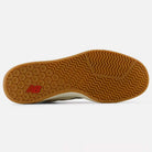 The image shows the gum-colored rubber sole of the 440 HTW Timberwolf White New Balance Numeric Suede Skateboarding Shoes, featuring a textured pattern and a red New Balance logo near the heel.