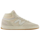 The 440 HTW Timberwolf White New Balance Numeric Suede Skateboarding Shoe is a beige high-top sneaker featuring white laces, a prominent white N logo on the side, a perforated heel, and a light brown gum sole. Equipped with a durable ABZORB midsole for superior comfort and support, this versatile skate shoe is shown from the side against a white background.