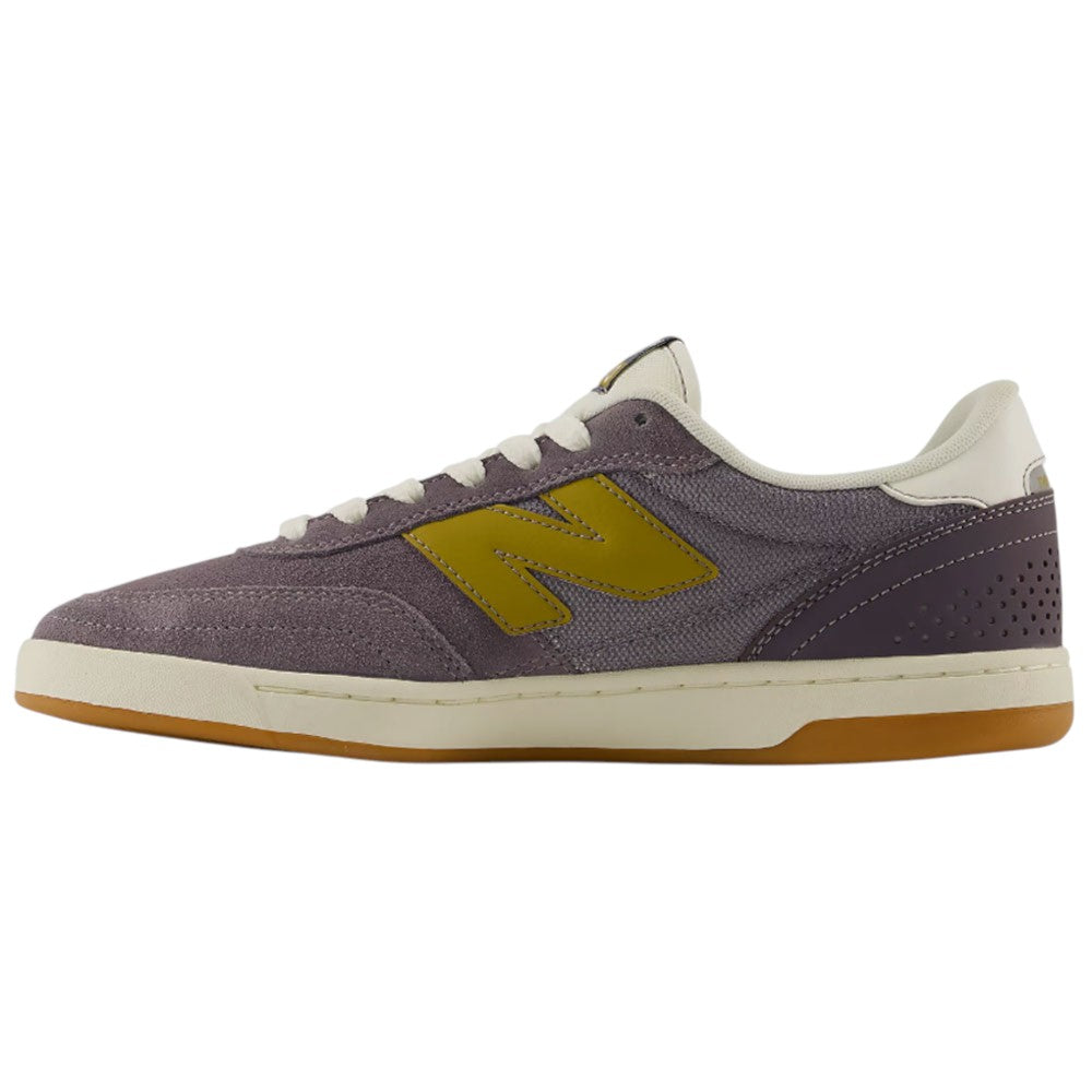 The 440 PRB Neptune Gray Seamoss New Balance Numeric Suede Skateboarding Shoe features a purple suede upper with a yellow N logo, white laces, and a light brown rubber sole. Displayed in side profile against a plain white background, it also includes a durable ABZORB midsole for enhanced comfort and support.