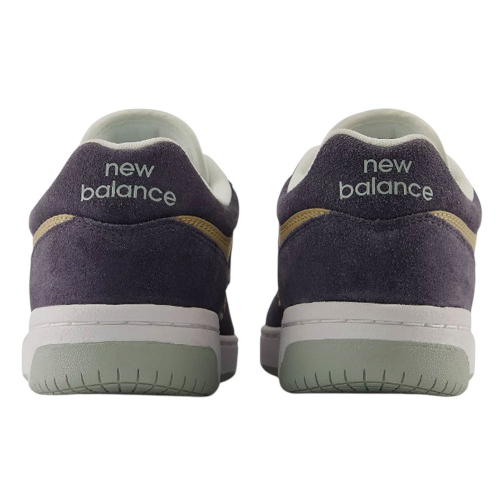 Back view of two 480 NAD New Balance Numeric Suede Skateboarding Shoes in dark purple suede with white midsoles, sage green outsoles, and the brand name embroidered on the heels.