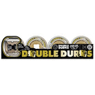 A set of OJ Wheels 53mm Double Duro Gum Hardline skateboard wheels in beige with black and gold dice graphics, featuring 101a outer and 95a inner durometer.