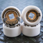 Close-up of four 53mm Double Duro Gum Hardline 101a 95a OJ Wheels: two upright display the black and gold OJ Wheels branding, while two lie flat, all in white.