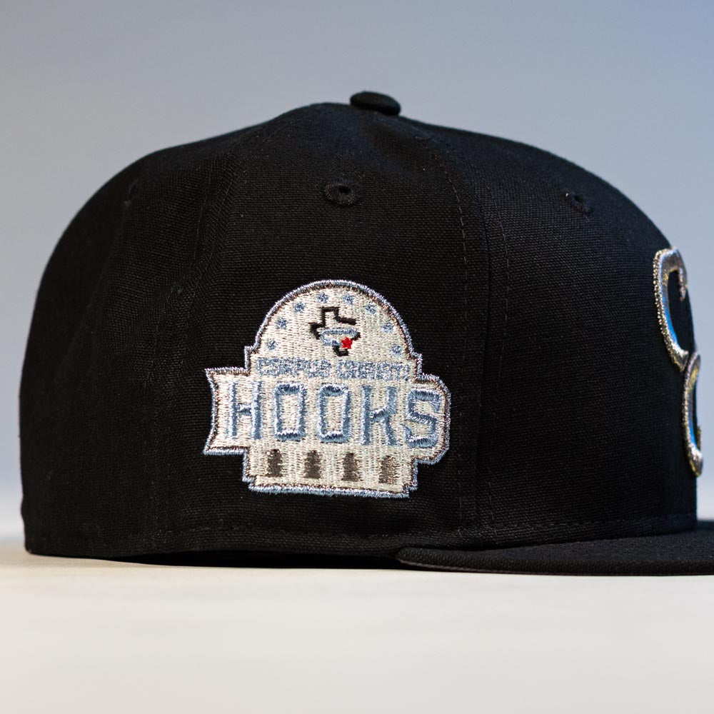 The Eagle Claw Canvas Black Corpus Christi Hooks New Era 5950 Fitted Hat features a dome-shaped embroidered Hooks patch with stars and a red accent, making it perfect for Corpus Christi Hooks fans.