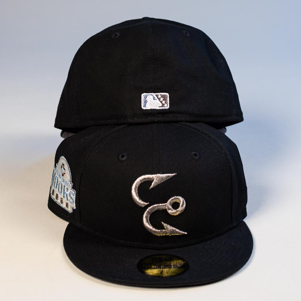 Two Eagle Claw Canvas Black Corpus Christi Hooks New Era 5950 Fitted hats are stacked. The front features a silver two-hook logo and a Hooks side patch; the back cap displays a small MLB logo. Both hats have flat brims.