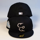 Two Eagle Claw Canvas Black Corpus Christi Hooks New Era 5950 Fitted hats are stacked. The front features a silver two-hook logo and a Hooks side patch; the back cap displays a small MLB logo. Both hats have flat brims.