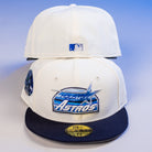 Two KB1 Rushmore 35th Chrome Navy Houston Astros New Era 5950 Fitted hats are shown—one displays the team logo on the front, the other shows the MLB logo on the back. Stickers and tags appear on the front cap.