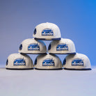 Six KB1 Rushmore 35th Chrome Navy Houston Astros New Era Hat 5950 Fitted caps are stacked in a pyramid against a blue gradient background.