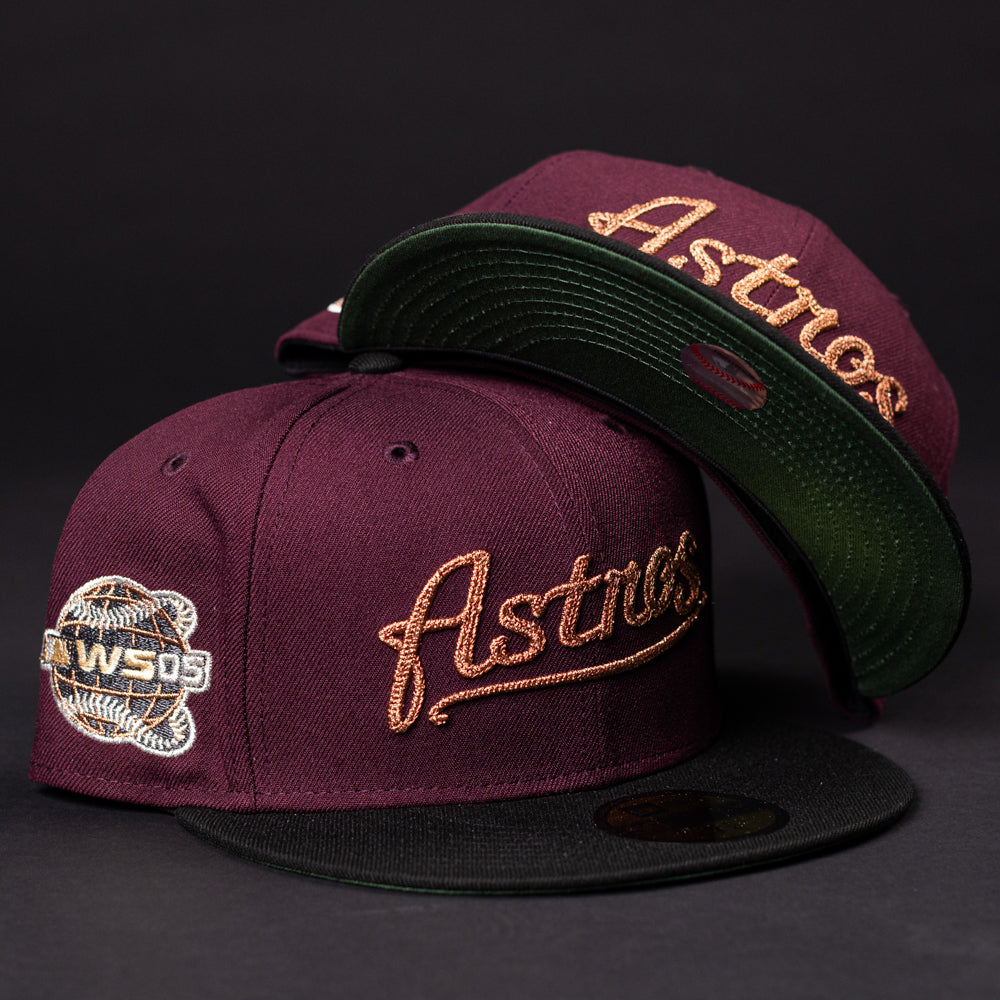 Two 05 Debut Maroon Black Houston Astros New Era Hat 5950 Fitted caps, each with a black brim and gold "Astros" embroidery; one includes a 2005 World Series patch. Both are displayed against a dark background.