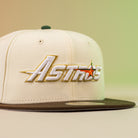 The Oompa Pink Box Houston Astros New Era Hat 5950 Fitted features "Astros" embroidered in gold and white with an orange star, a cream crown, dark green brim, and gradient yellow-green background—perfect for dedicated fans.
