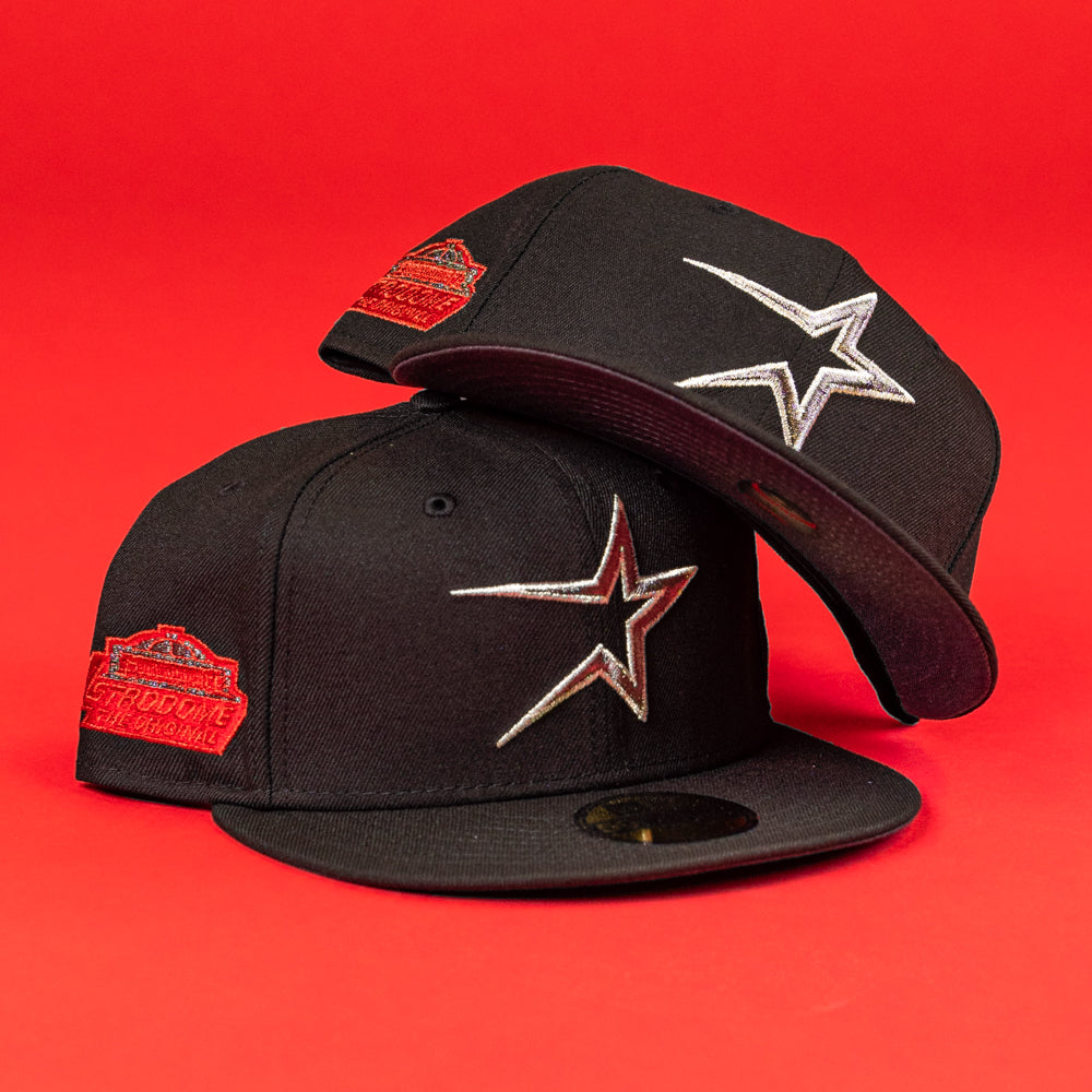 Two The Shootah Black Silver New Era Hat 5950 Fitted caps, featuring star logos on the front and a red patch on the side, are stacked against a solid red background.