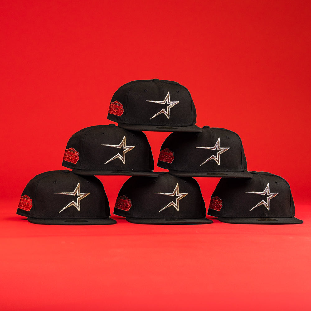 Six The Shootah Black Silver New Era Hat 5950 Fitted caps, featuring a silver star logo and a red side patch, are arranged in a pyramid formation against a solid red background.