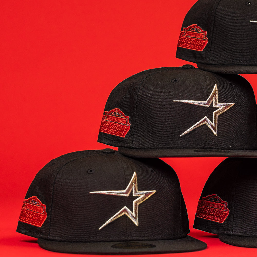 The Shootah Black Silver New Era Hat 5950 Fitted, featuring a silver star logo and red patch, is stacked against a solid bright red background.