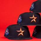 Three black New Era 5950 Fitted caps with orange star logos and blue 45th Anniversary patches are stacked against a red background, echoing the design of the 6am in Texas Navy Red White New Era Hat 5950 Fitted.