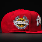 The Sunnyside Bo Bundy WS05 Houston Astros New Era Hat 5950 Fitted is a red cap with an embroidered yellow globe, silver laurels, and "WORLD CLASS" on the side—a unique design from New Era.