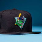 The Flamingo and Chill Bo Bundy 2022 Houston Astros New Era 5950 Fitted Hat features a colorful embroidered green cartoon character with a yellow bat on a blue triangle—ideal for Astros fans seeking standout style.