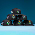 Six Flamingo and Chill Bo Bundy 2022 Houston Astros New Era Hat 5950 Fitted caps are stacked pyramid-style against a blue background, each featuring a vibrant, colorful embroidered patch on the front left panel.