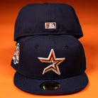 The Highclass 45th Houston Astros New Era Hat 5950 Fitted features a navy blue design with an embroidered orange and gold star logo, a commemorative side patch, and MLB logo, displayed against an orange background.