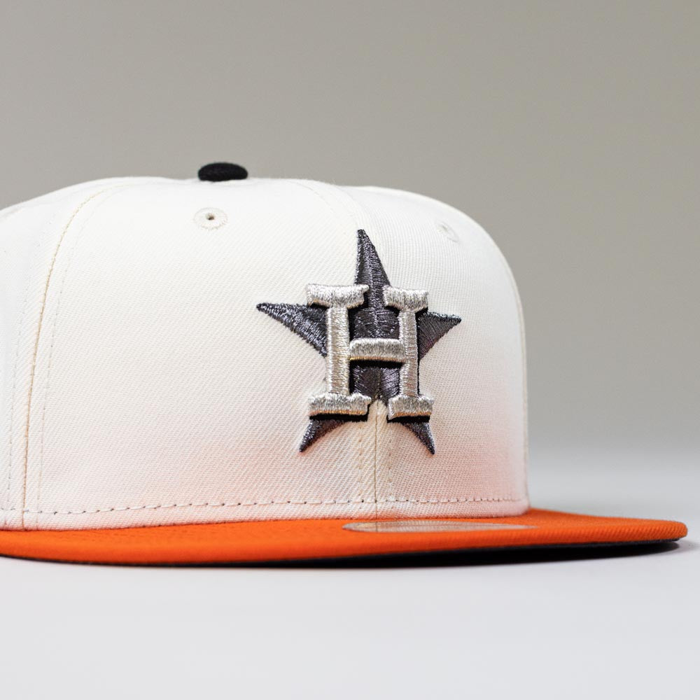 The Orange Soda New Era WS22 Houston Astros 5950 Fitted Hat features a white crown, orange brim, black button, and an embroidered H over a star—ideal for showcasing Astros pride with style.