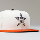 The Orange Soda New Era WS22 Houston Astros 5950 Fitted Hat features a white crown, orange brim, black button, and an embroidered H over a star—ideal for showcasing Astros pride with style.