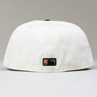 An Orange Soda WS22 Houston Astros 5950 Fitted New Era Hat is shown from the back, highlighting a small black and gold MLB logo near the bottom edge against a plain light gray background.