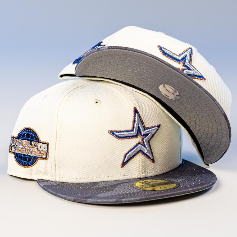 Two Dark:30 New Era Chrome Black Camo Houston Astros 5950 fitted hats, each featuring the Astros star logo, a World Series patch, and a sticker on the gray brim; one is upright, the other shows the underside of the brim.