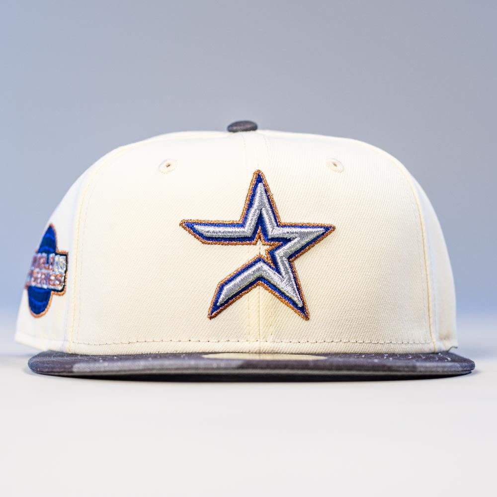 The Dark:30 New Era Chrome Black Camo Houston Astros 5950 Fitted Hat features a cream color, bold embroidered star with blue and gold outline on the front, gray brim, and a side patch, honoring the Astros in standout style.