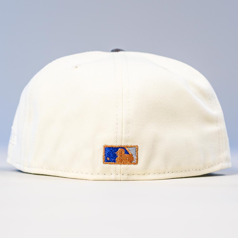 A Dark:30 New Era Chrome Black Camo Houston Astros 5950 Fitted Hat shown from the back, with a small embroidered MLB logo in blue, white, and gold near the bottom edge.