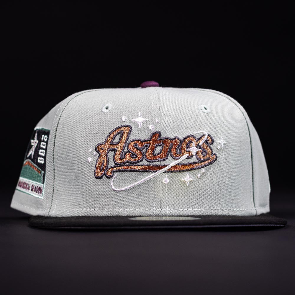 The Pixie Dust New 2000 Houston Astros New Era Hat 5950 Fitted features a gold and brown Astros logo, embroidered stars, and a commemorative side patch on a black and white design.