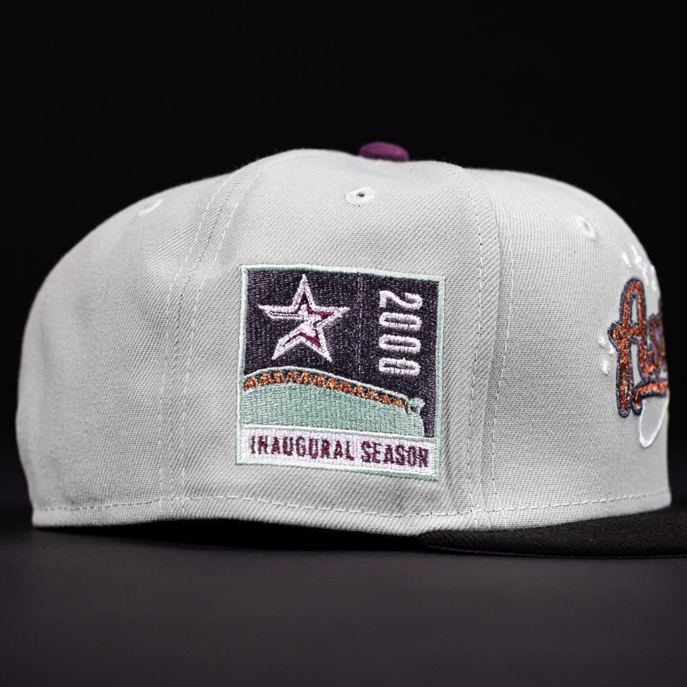The Pixie Dust New 2000 Houston Astros New Era 5950 Fitted Hat features a light gray crown, black brim, and a side patch with a star, “2000,” stadium graphic, and “INAUGURAL SEASON”—perfect for Astros fans.
