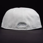 The Pixie Dust New 2000 Houston Astros New Era 5950 Fitted cap, shown from the back, displays "Astros" embroidered in silver on the bottom center against a black background.