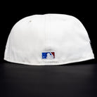The Red Soda New Era HOF Red Black Chrome Houston Astros 5950 Fitted Hat is shown from the back, featuring the MLB logo embroidered above the bottom edge, set against a black background.
