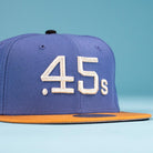 The Harbor Mark Canvas Houston Astros New Era 5950 Fitted Hat features a blue design, yellow brim, and white embroidered .45s text on the front—perfect for fans and collectors. Displayed against a light blue background.