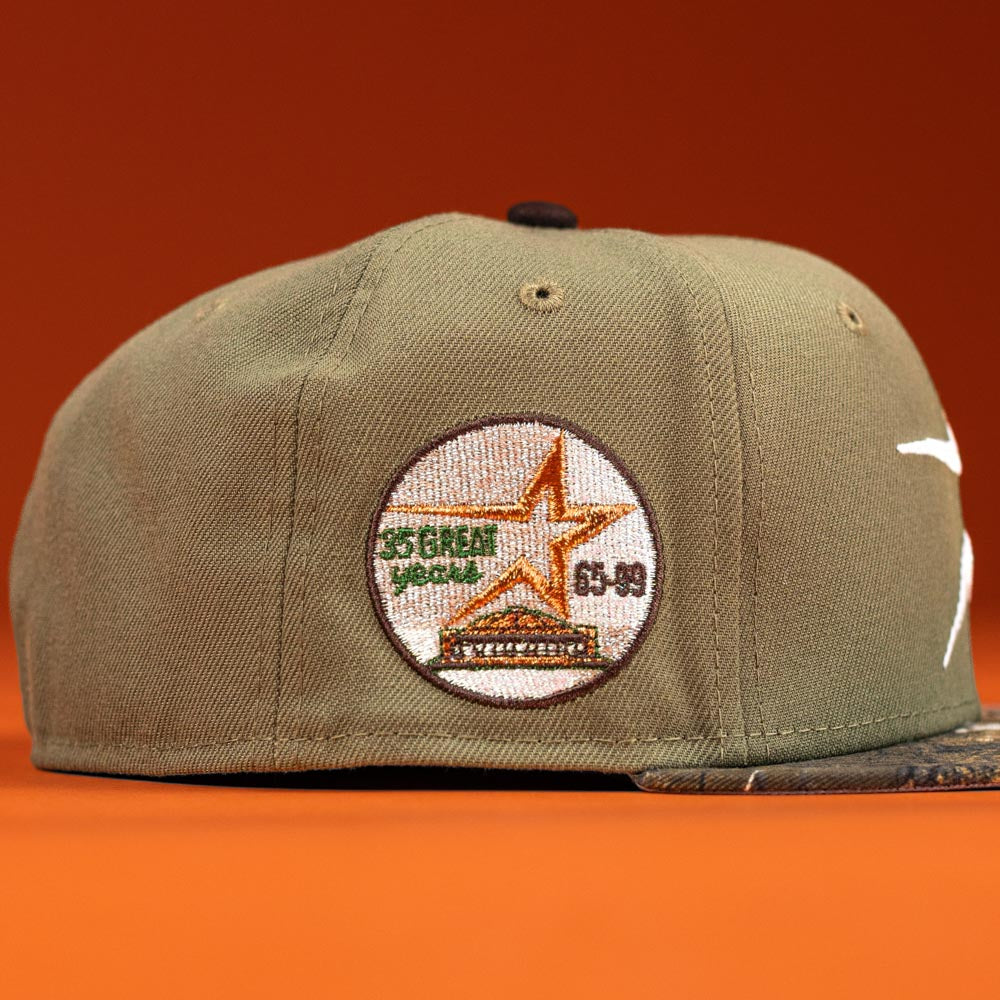 Pre-Order the Wall Hanger New Era Bark Real Tree Houston Astros 5950 Fitted Hat, featuring a khaki-green design with a round embroidered patch and orange background. Convenient shipping options available.
