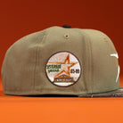 Pre-Order the Wall Hanger New Era Bark Real Tree Houston Astros 5950 Fitted Hat, featuring a khaki-green design with a round embroidered patch and orange background. Convenient shipping options available.