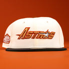 The Rustic Sunset Houston Astros New Era Hat 5950 Fitted is a white cap with "Astros" and a star logo embroidered in orange and gold on the front, features a black brim, set against an orange background.