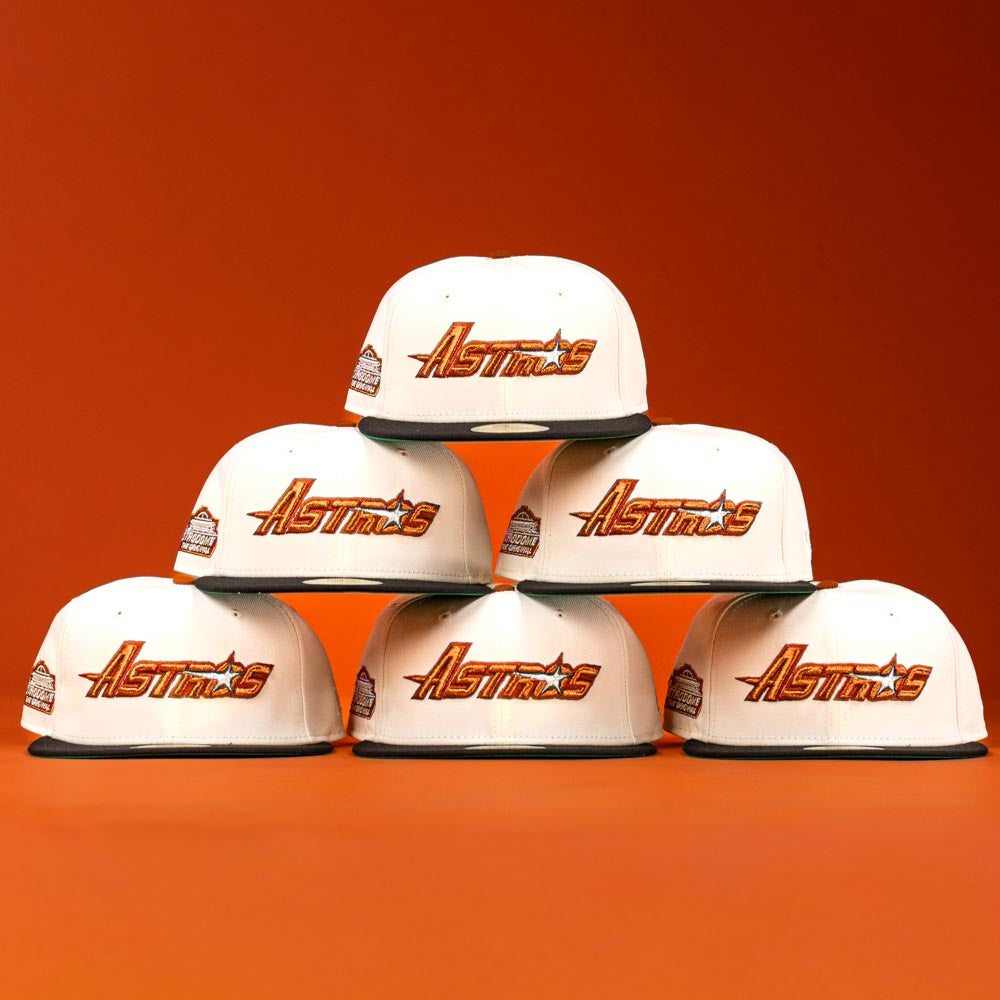 Six Rustic Sunset Houston Astros New Era Hat 5950 Fitted caps are arranged in a pyramid, each displaying an orange logo against a vibrant orange background.