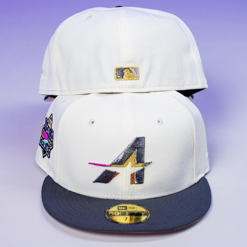 Two Trilltiberi Rushmore WS22 Chrome Graphite Houston Astros New Era Hat 5950 Fitted caps, featuring an “A” logo, colorful side patch, gold MLB back logo, and a size sticker on the gray brim, are shown against a purple background.
