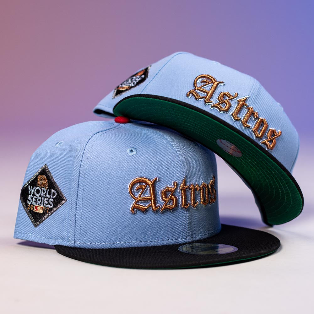 Two Sicko Mode Rushmore 2017 B Blue Black Houston Astros New Era 5950 Fitted hats with gold Astros lettering and a World Series 2022 patch are stacked against a purple background.
