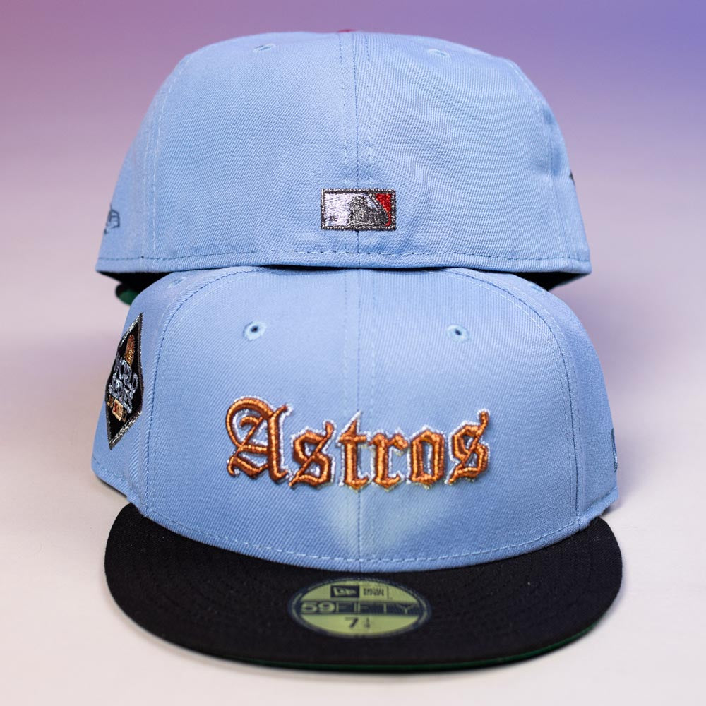 Two Sicko Mode Rushmore 2017 B Blue Black Houston Astros New Era 5950 Fitted hats are stacked. One shows “Astros” in orange with a side patch, the other displays the MLB logo. Both have black brims and a New Era sticker—ideal for Astros fans.