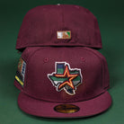 Two Pinkerton 2.0 Rushmore 2000 Maroon Houston Astros New Era 5950 Fitted hats are shown: the front hat has a Texas outline with star and Astros logo, side patch; the back displays a small embroidered Texas flag patch.